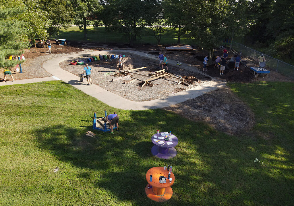Volunteers build the nature play area on Thursday at Derby Ridge Elementary.